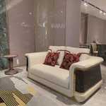 Cream Leather Sofa with Dark High-Gloss Wood Panels, Monogram Cushions and Metal Base Trim
